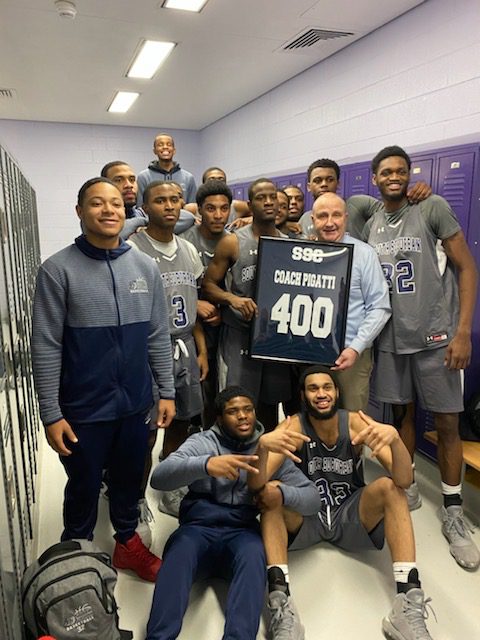 Bulldogs Head Coach John Pigatti and the 2020 Basketball Team celebrate his 400th win at South Suburban College.