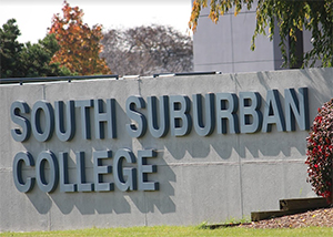 A picture of a sign on the Main Campus in autumn that says, "South Suburban College".